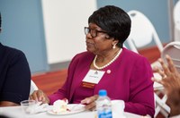 Alum listening to presentation