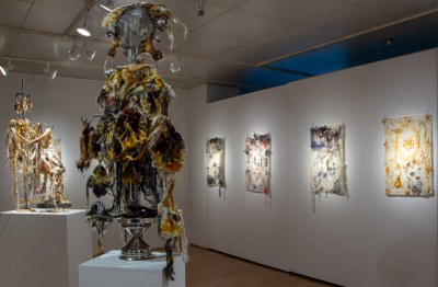 Multiple art pieces by Pablo Garcia Lopez in the York College gallery space including sculptures, painting and on-screen
