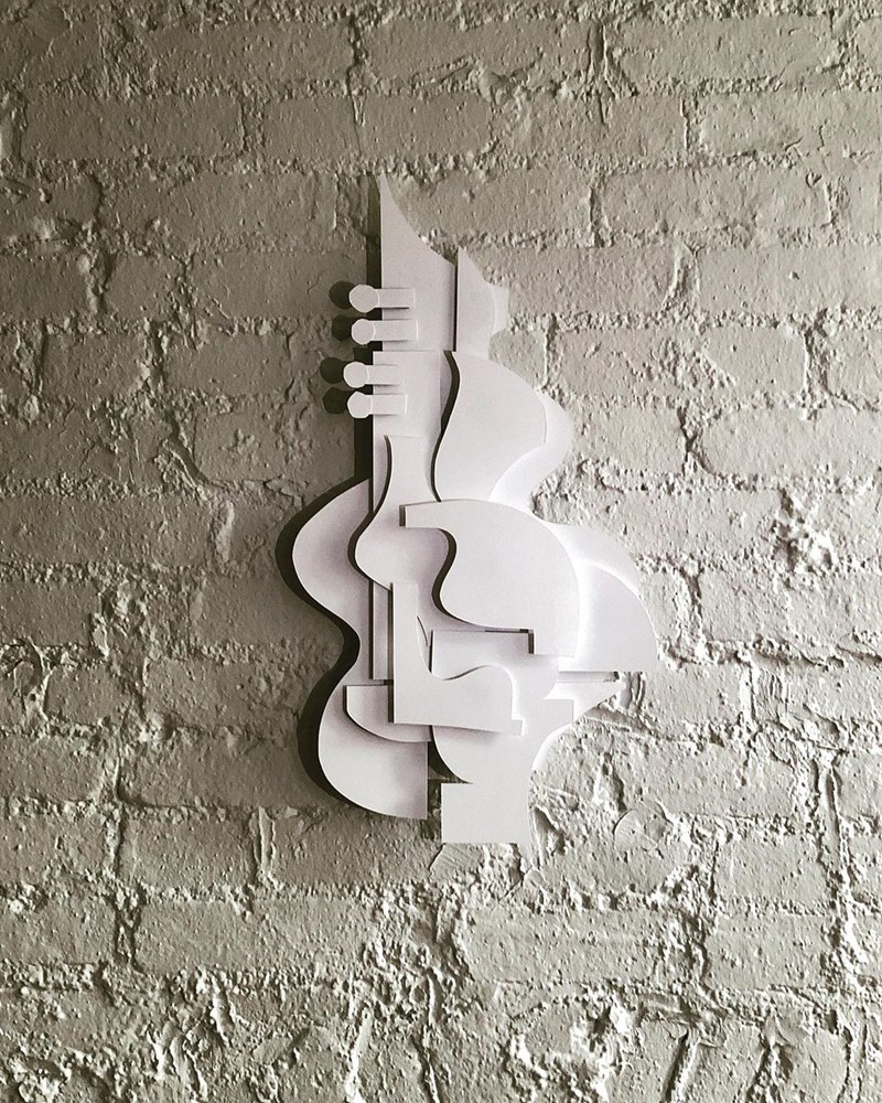 Construction paper formed in a way that looks like several instruments.