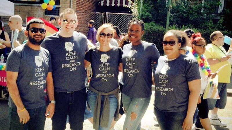 Five researchers wear "Keep calm and research on" shirts
