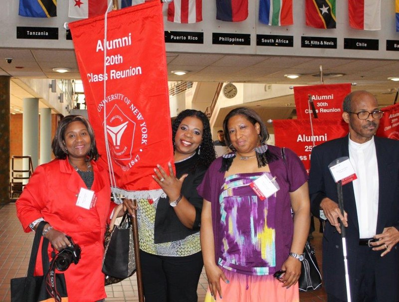 Alums holding their class banner