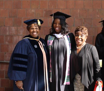 Dr. Phelps and Mondell Sealy posing with AKA Soror graduate