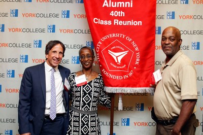 Alums posing with their 40th Class Reunion banner