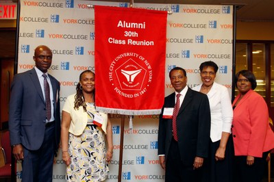 Alums posing with their 30th class reunion banner
