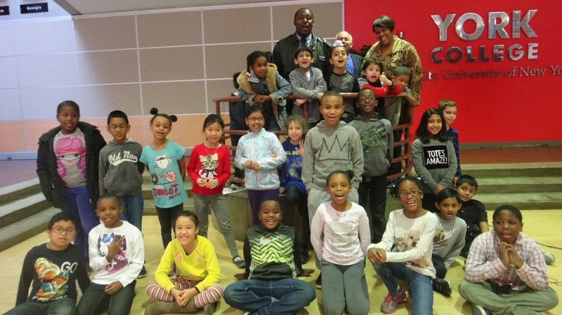 Pilot Leighton Jamieson (far left, last standing row), third-grade MAA teacher Kyshia Lawrie, and third-grade students visit York College in Jamaica, New York.