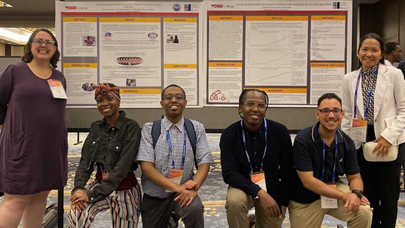 Group Picture in front of our scholar's posters (Left) Dr. Eleanor Sayre, NSF Program Director (2nd) Chanael Decembre (3rd) Jonathan Shields (4th) Terrence Coggins (5th) Julian Feliciano (right) Dr. Thitima Srivatanakul, Assistant Professor of Math and Computer Science Department and Principle Investigator of the S-STEM Scholarship Program at York.