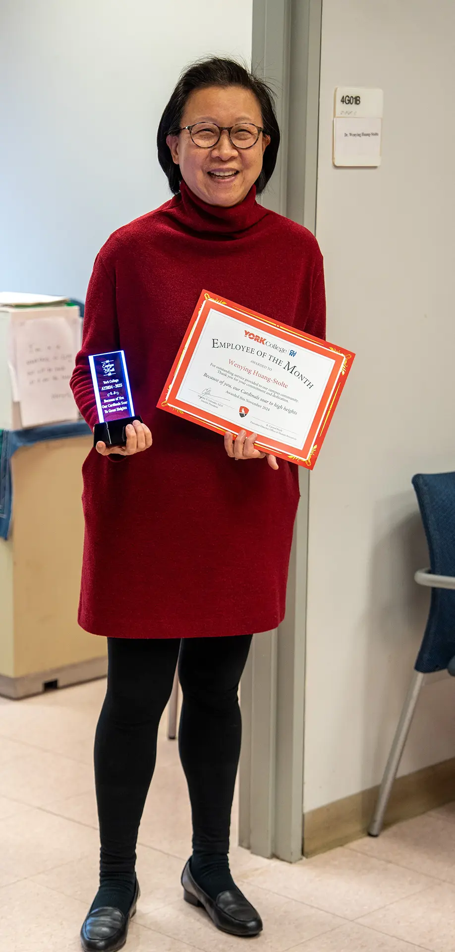 Dr. Wenying Stolte proudly shows off her Employee of the Month assets.