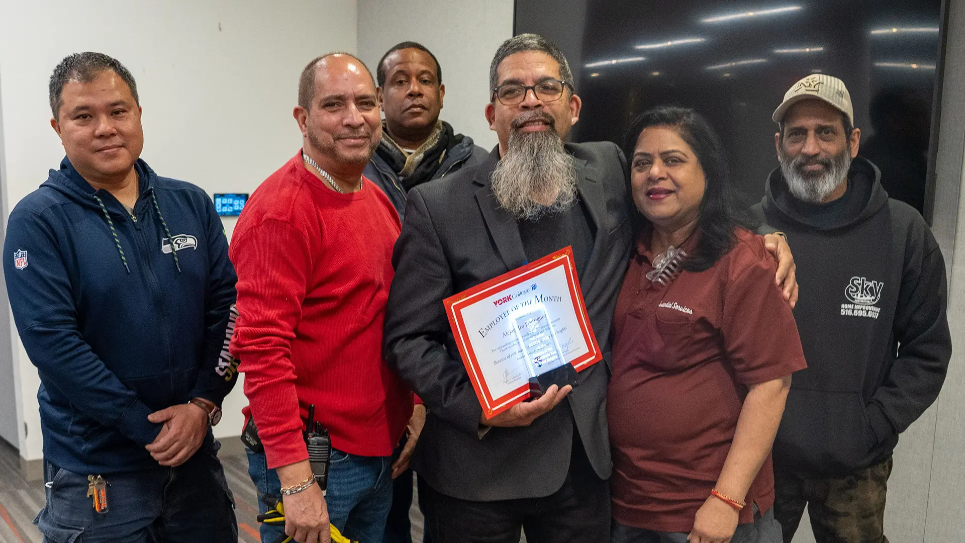 Alex shares his honor with members of his team