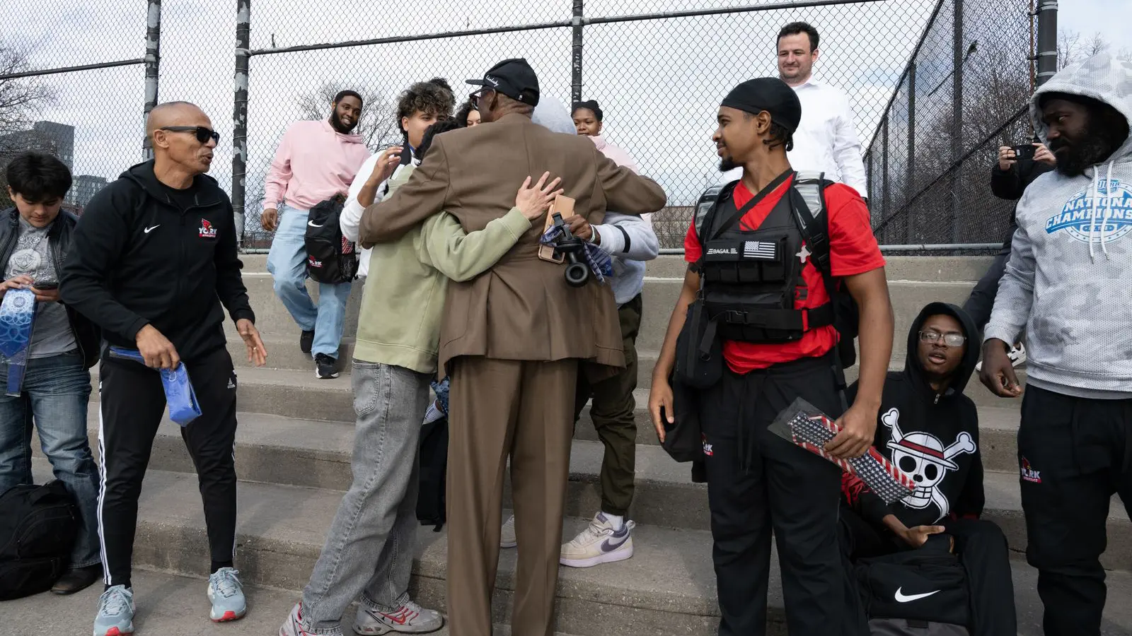 Students receive hugs from the Olympic great