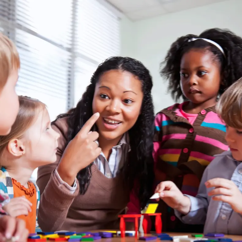 Teacher Engaging with Preschool Students